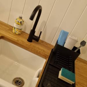 a kitchen counter with a black juicer on a sink at Tolverne Luxury Shepherd's Hut in Holsworthy