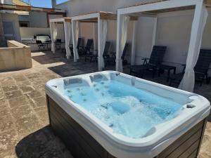 a jacuzzi tub in the middle of a patio at Dimora Assuntina Martano in Martano