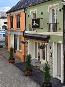 a building with potted plants in front of it at Rookery Lane Food and Lodging in Kenmare