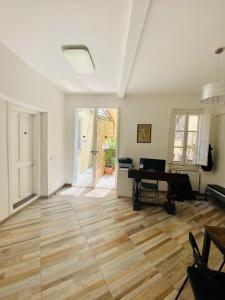 a living room with a wooden floor and a piano at My Friends in Florence