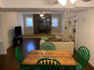 a living room with a table and chairs and a couch at 6 Bedroom house 15 minutes from iah airport. in Houston