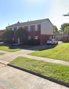 a house with a car parked in front of it at 6 Bedroom house 15 minutes from iah airport. in Houston