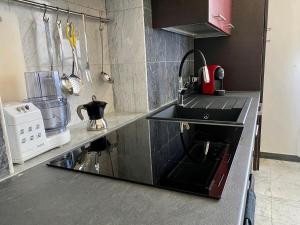 a kitchen with a sink and a stove top oven at Affittacamere Torre Dell'Arte in Torre del Lago Puccini