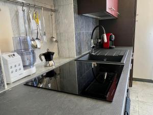 a kitchen with a sink and a stove top oven at Affittacamere Torre Dell'Arte in Torre del Lago Puccini +4 photos