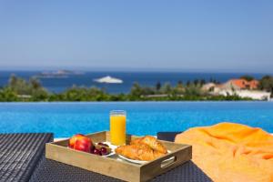 a tray of food and a glass of orange juice at Apartmani Ana in Mlini