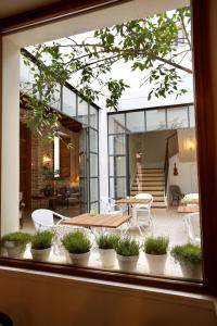 a view of a patio with potted plants in a window at Hotel Amadeus Sevilla in Seville