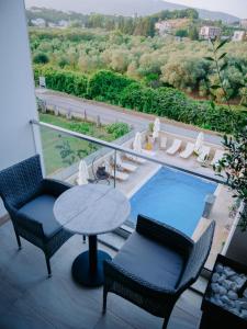 a balcony with a table and chairs and a swimming pool at Onyx Luxury in Ulcinj