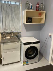 a washing machine and a washer and dryer in a room at Homely Cottage in Hawker +4 photos