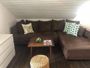 a brown couch in a living room with a table at Apartment Dubravka Iza Roka in Dubrovnik