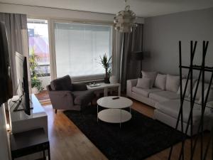 a living room with a couch and a table at Central Tammela 80m2 in Tampere
