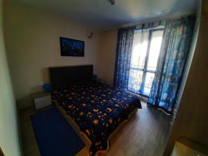 a bedroom with a bed and a window with curtains at Cascadas Ravda in Ravda +14 photos