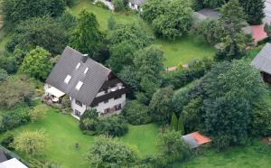 an overhead view of a large house with trees at Ferienwohnung-Gottorf in Ulsnis