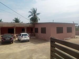 a house with two cars parked in front of it at Feel At Home & be close to the Labadi Beach (5min) in Accra