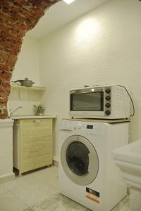 a microwave on top of a washing machine in a kitchen at Top Center Semi-detached Apartment Studio in Sofia