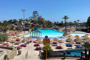 a pool at a resort with a roller coaster at Precioso apartamento en Benicasim in Benicàssim