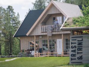 a man standing on the balcony of a house at Trasti & Trine Boutique Hotel in Alta