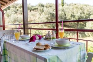 a table with a table cloth with breakfast foods on it at Tasia's Studios in Perivólion