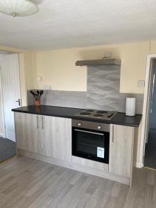 a kitchen with a stove and a counter top at Fox and Hounds Apartment in Willingham