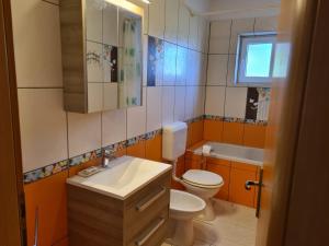 een badkamer met een wastafel, een toilet en een bad bij Apartments Manuel in Rab