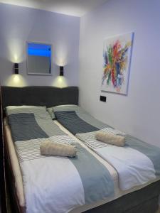 two beds sitting next to each other in a bedroom at Villa Piran luxury apartments in Piran
