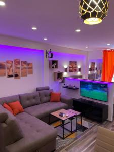a living room with a couch and a flat screen tv at Villa Piran luxury apartments in Piran