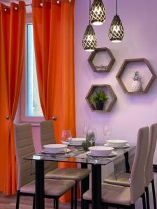 a dining room with orange curtains and a table and chairs at Villa Piran luxury apartments in Piran