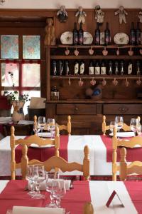 a dining room with a table with wine bottles at Hotel Paramont in Valgrisenche