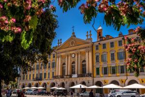 a large yellow building with a clock on it at Aparthotel AMMI Vieux Nice in Nice