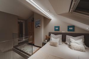 a bedroom with a bed and a glass staircase at Sunset Apartment in Pomorie