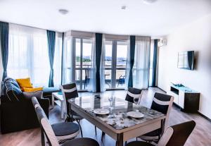 a living room with a table and chairs and a couch at Donchevi Apartments in Primorsko
