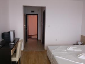 a bedroom with a bed and a desk and a television at Villa Lazuren Bryag 2 in Chernomorets