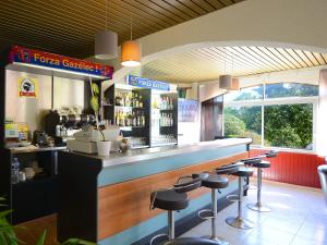 a bar in a restaurant with stools at a counter at U Libecciu in Macinaggio