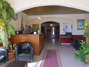 a lobby with a waiting area with chairs and a desk at U Libecciu in Macinaggio