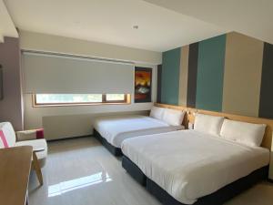 Voodi või voodid majutusasutuse Fu Kuang Hotel toas