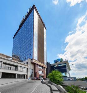 a tall glass building with a street in front of it at Gagarinn in Odesa