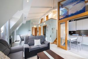 a living room with a couch and a table at LUXURY DUPLEX PENTHOUSE WITH TERRACE-OLD TOWN in Donostia-San Sebastián