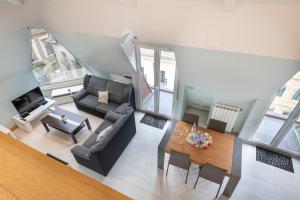 an overhead view of a living room with a couch and a table at LUXURY DUPLEX PENTHOUSE WITH TERRACE-OLD TOWN in Donostia-San Sebastián