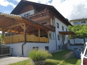a house with a wooden pergola on top of it at Haus Im Grünen in Villach
