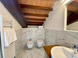 a bathroom with a sink and a toilet at Residenza d'epoca dei Fondachi in Sarzana +113 photos