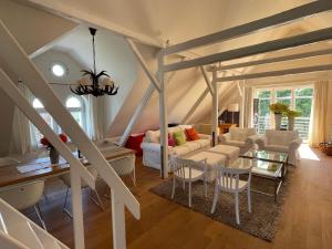 a living room with a couch and a table at Landhaus am Rheinsteig & Loreley in Lykershausen