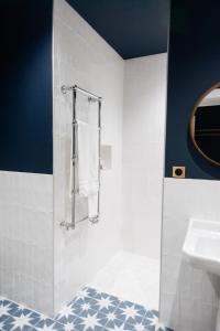 La salle de bains est pourvue d'un lavabo, d'une douche et de serviettes. dans l'établissement Hotel de Fouquet - Chambres d'hôtes, à Metz