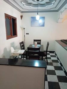 a dining room with a table and chairs at Al-marsa2 in Al Hoceïma