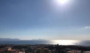 a view of the ocean from a city at Hotel Sakura in Torre del Greco