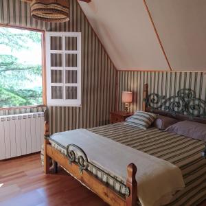 a bedroom with a bed and a large window at Chalet in legno in Campo di Giove
