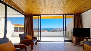 a living room with a view of the ocean at Albufeira, Sea Balcony (11) in Albufeira