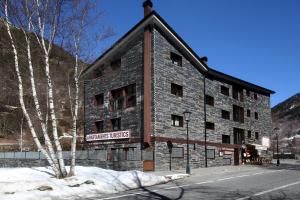 a large building with a clock on the side of it at Apartaments Turístics Prat de Les Mines in Ordino