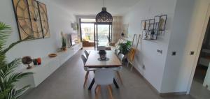 a dining room with a table and chairs at Sunset Waves Benidorm by Mar Holidays in Benidorm