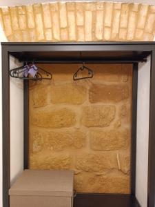 a room with a brick wall with a shelf and a box at A Cantunera LittleHouse in Agrigento +22 photos