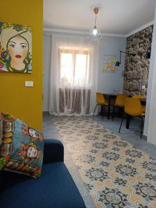 a living room with a couch and a table at A Cantunera LittleHouse in Agrigento