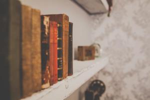 a row of books sitting on a shelf at Antique House B&B in Portrush